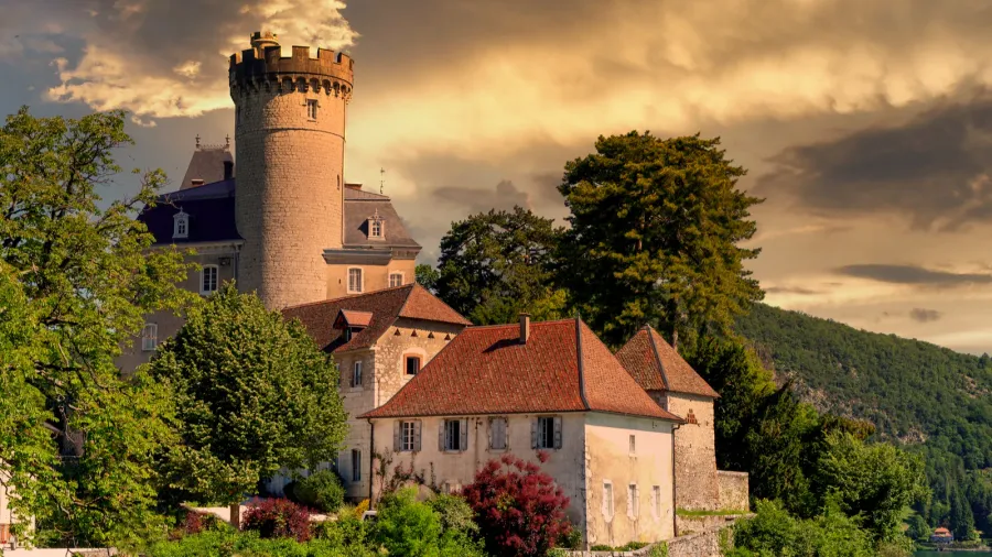 a medieval castle on annecy lake in alpes mountains france