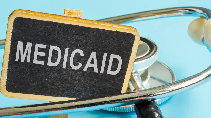 a plate with word medicaid and a stethoscope