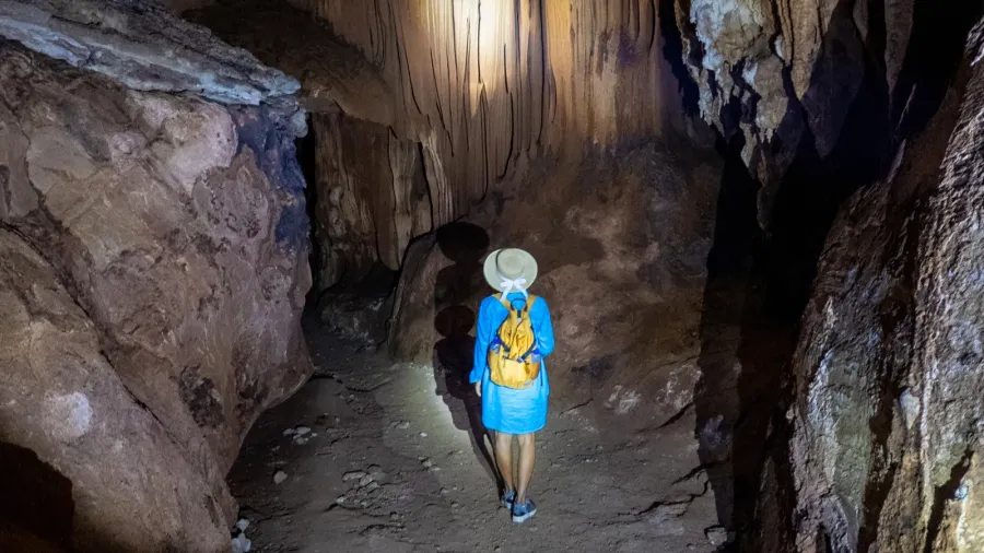 a traveler explores the enchanting caves of khao sok thailand