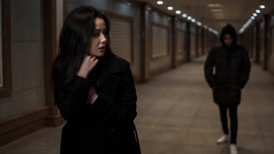 a young beautiful woman walks through an underground passage at