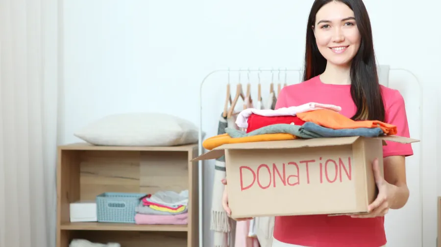 a young girl volunteer collects a box of donations for