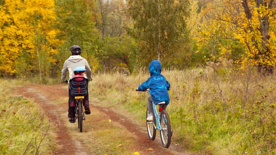 active family on bikes in autumn park