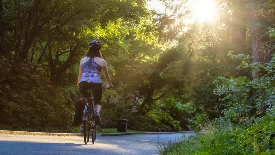 adventurous white caucasian adult woman riding a road bicycle