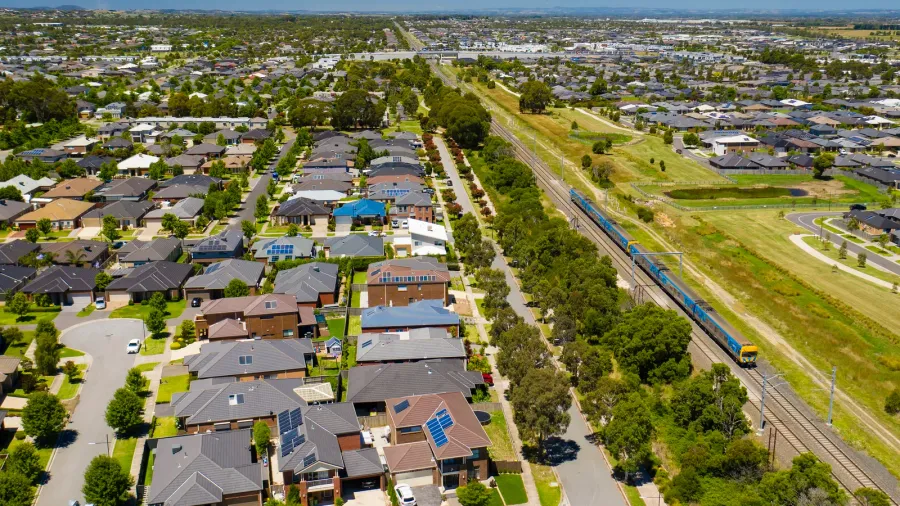aerial view of an outer suburb in melbourne with train