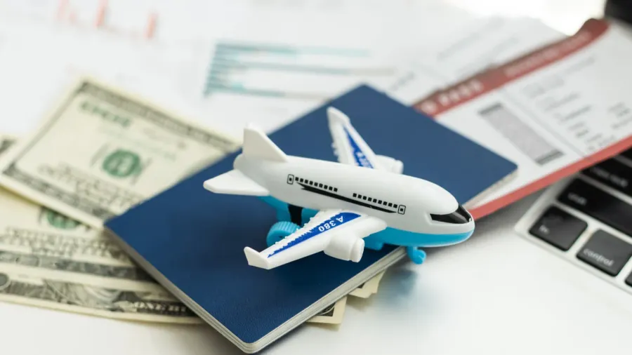 air tickets passports money and toy plane on table high