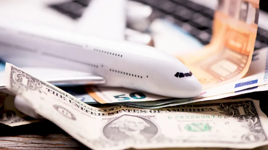 aircraft banknotes on a notebook travelling concept