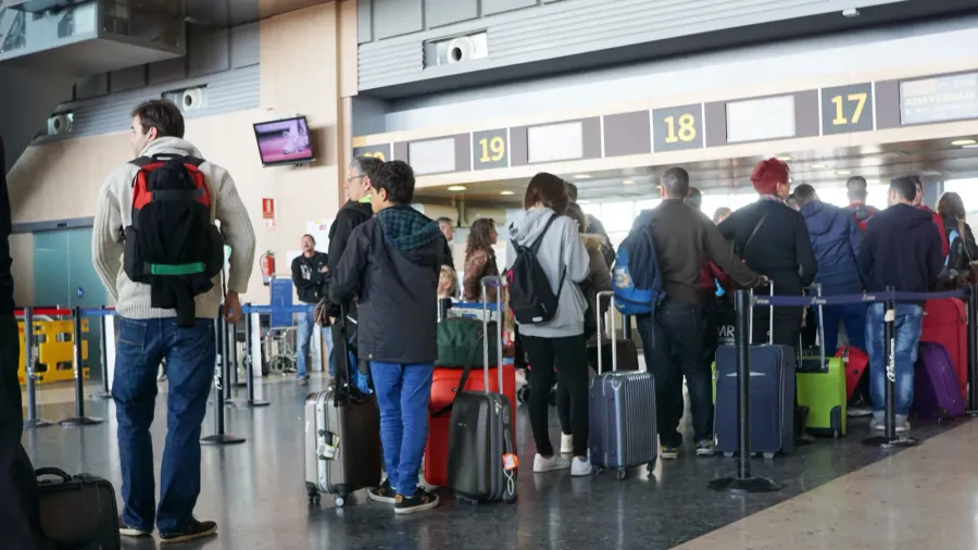 Airline passengers queued at the departure gates.