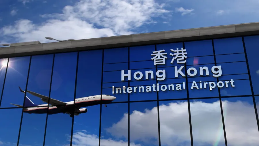 airplane landing at hong kong mirrored in terminal