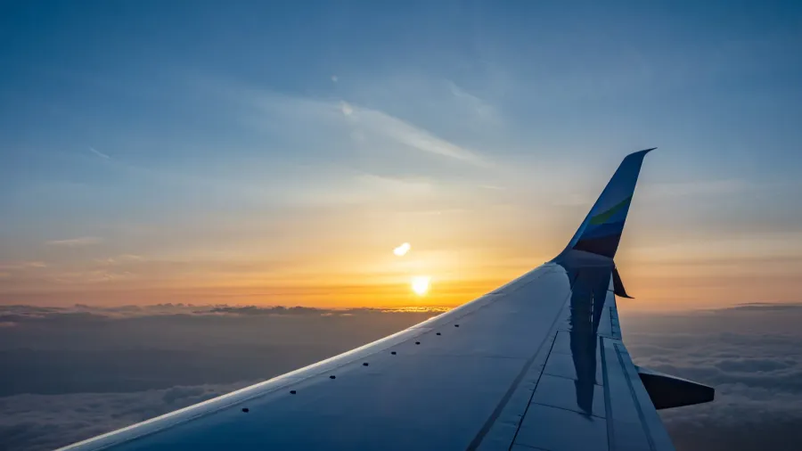 alaska airlines plane wing over cloudscape at sunset usa