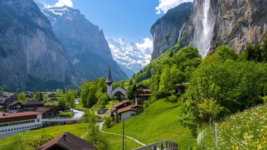 amazing alpine landscape in lauterbrunnen village with church and waterfall
