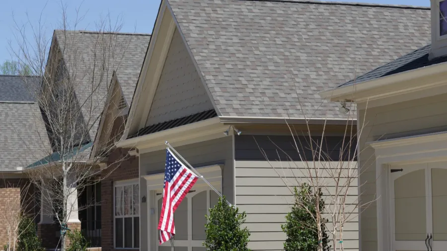 american flag on row of townhouses