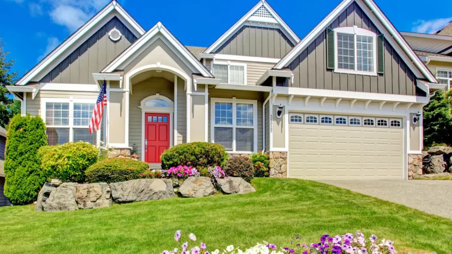 american house with beautiful landscape and vivid flowers