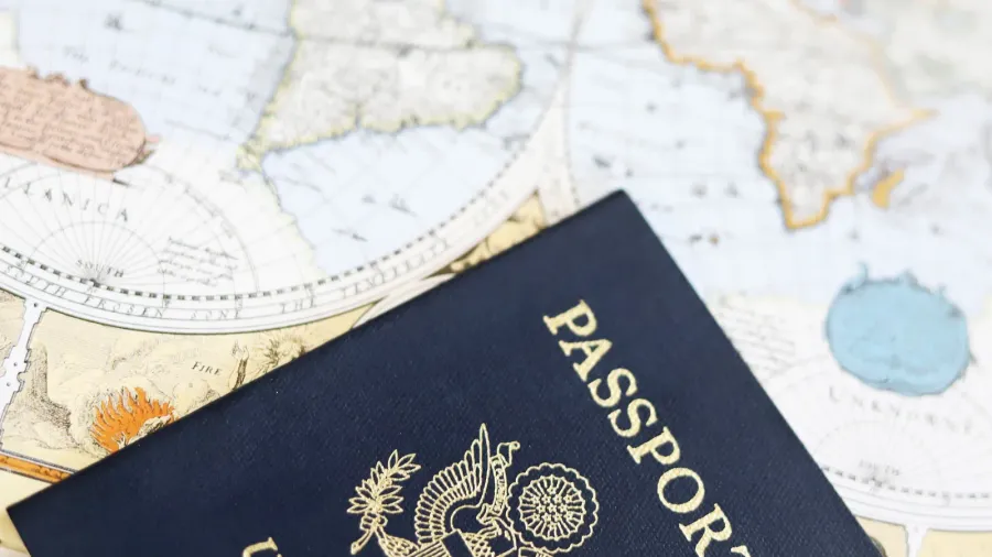 american passport and antique world map travel image