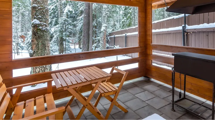 arbor with barbecue on a snowy yard