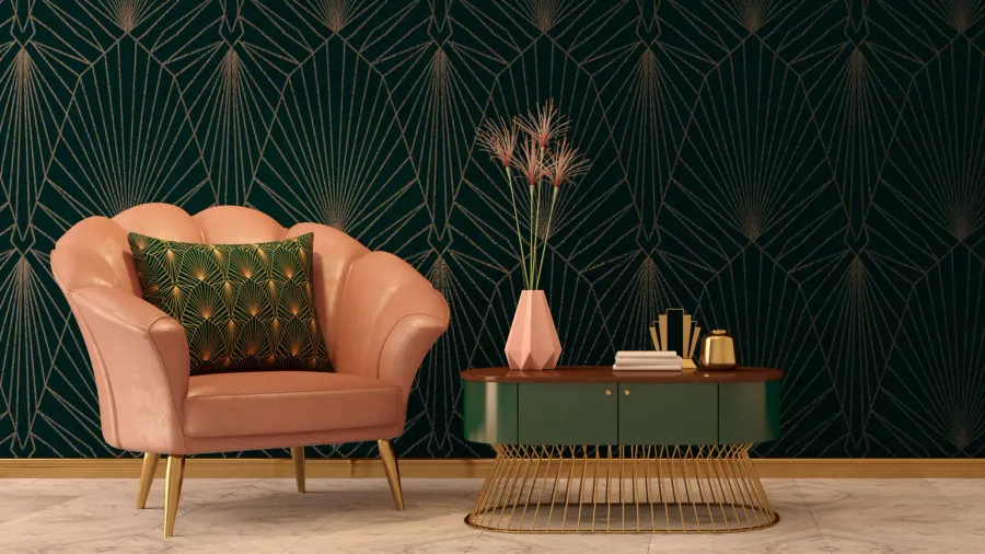 Art deco interior with geometric wallpaper, pink armchair with throw pillow, and a coffee table with books, vase, and metallic decor accents.
