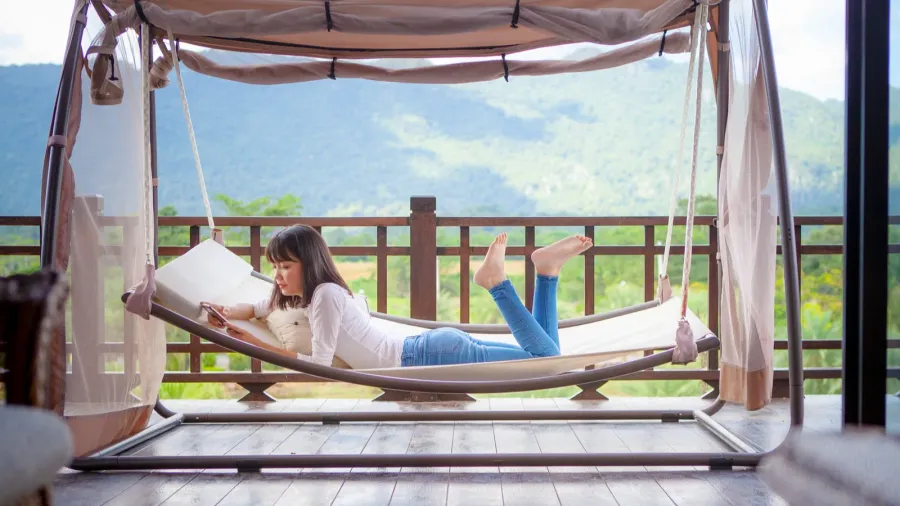 asian younger woman toothy smiling with happiness holding smart phone