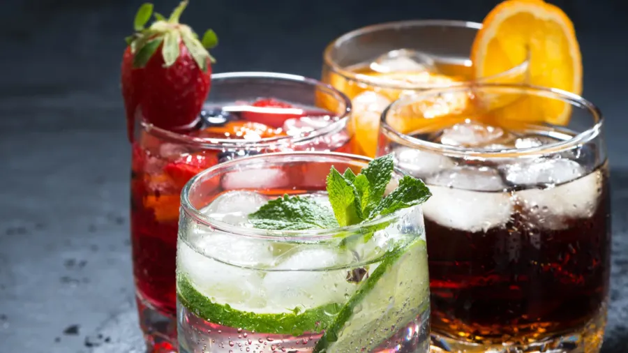 assortment of iced fruit drinks on a dark background