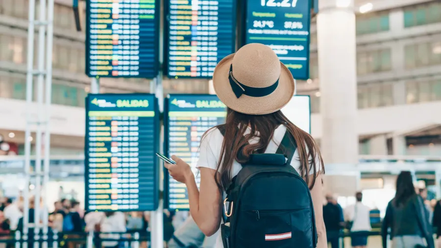 at the airport the girl looks at the scoreboard