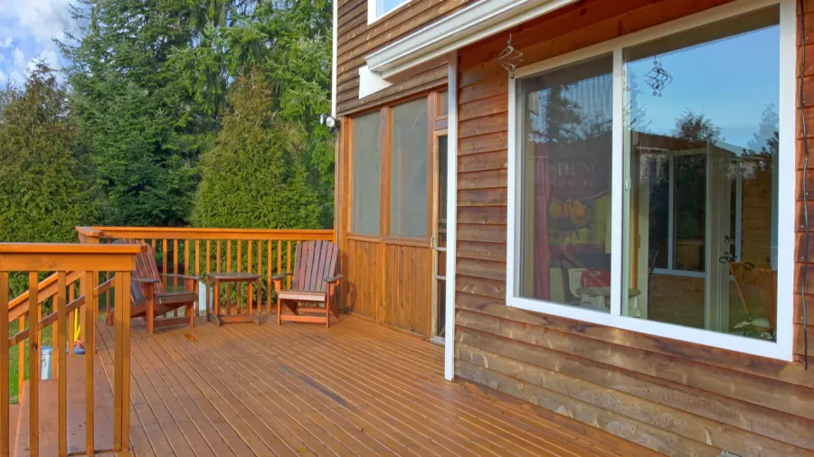 back of the house with a wooden deck