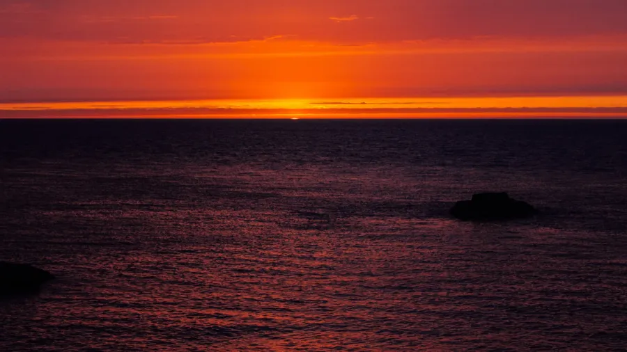 background with red sunset over the sea etretat normandy france