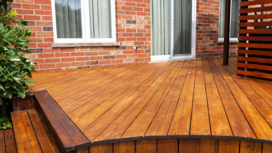 backyard wooden deck floor boards with fresh brown stain angled