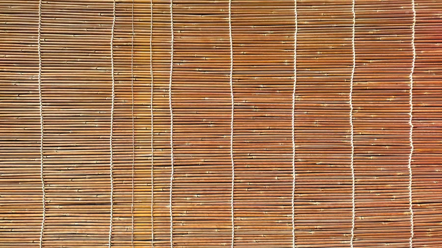 Weatherproof handwoven bamboo blinds on a window.
