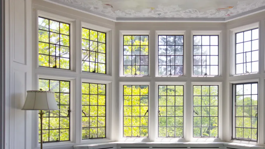 Full wall white window frames. Bay window.