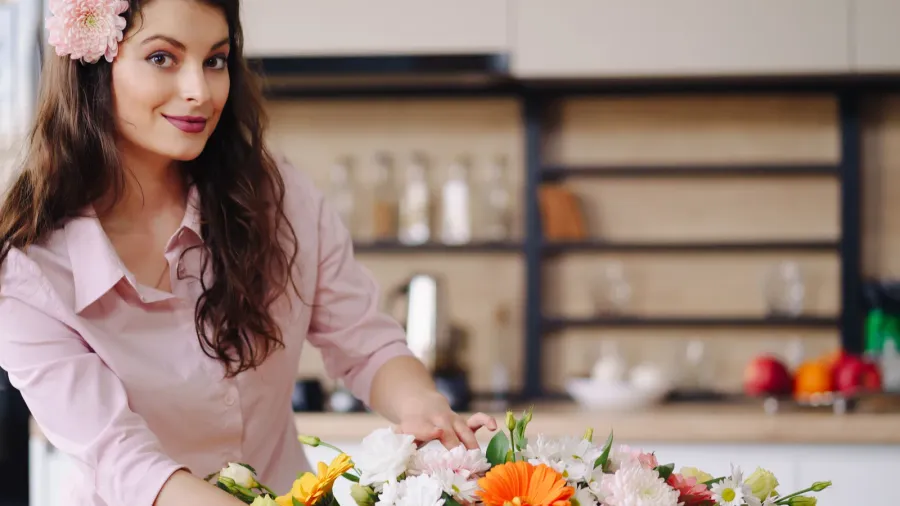 beautiful florist arranging a flower composition