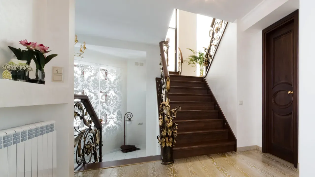 Intricate golden work on staircase.