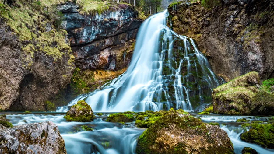 beautiful view of famous gollinger wasserfall with mossy rocks and