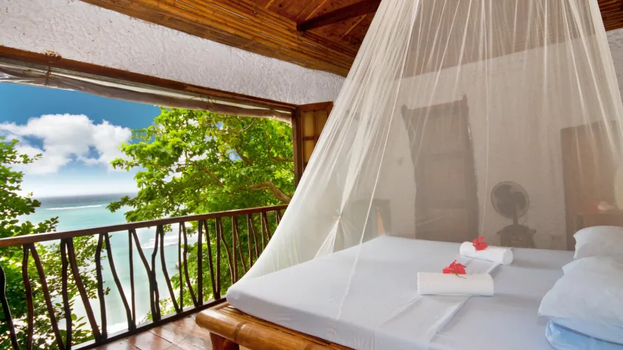 bedroom with canopy bed with sea view