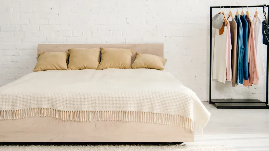big bed with cushions and blanket in teenage bedroom