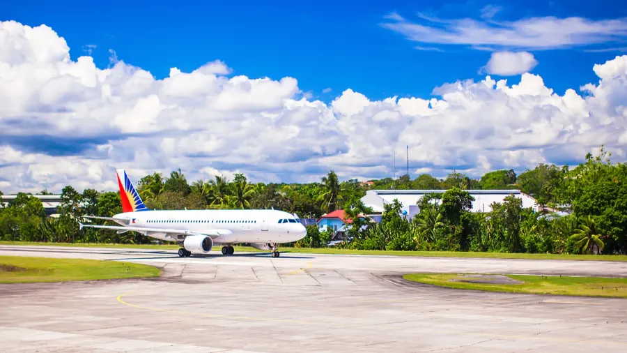 big plane is landing in a small airport on the