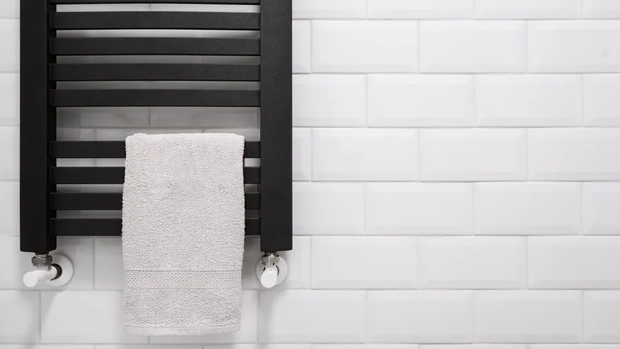 A towel hanging on a heated towel rack.