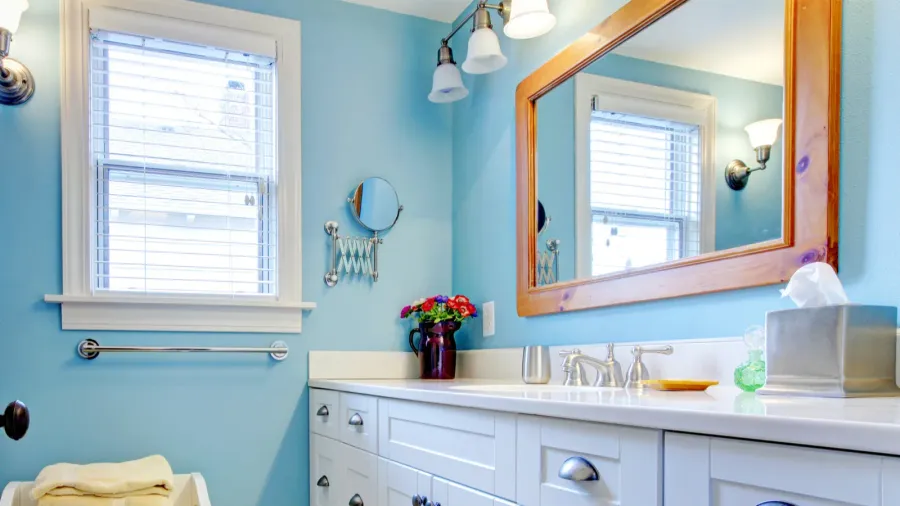 blue and white bathroom with lots of storage space