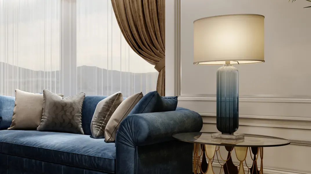 blue designer fabric sofa in front of the window with
