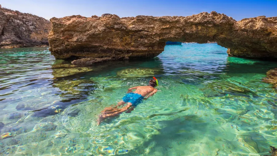 blue lagoon malta  snorkeling tourist at the caves of