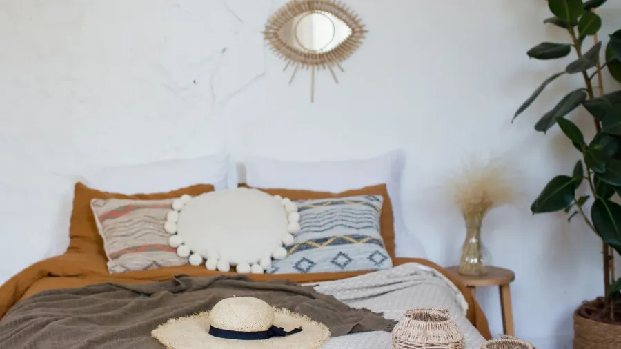 bohemian bedroom with natural materials decorations bed with different pillows