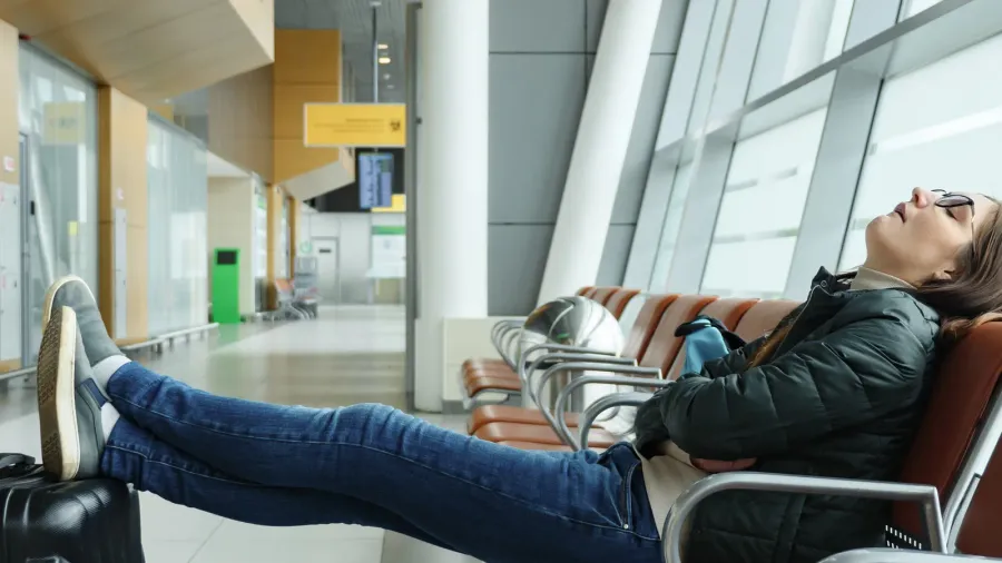 bored and tired young woman is waiting her flight in