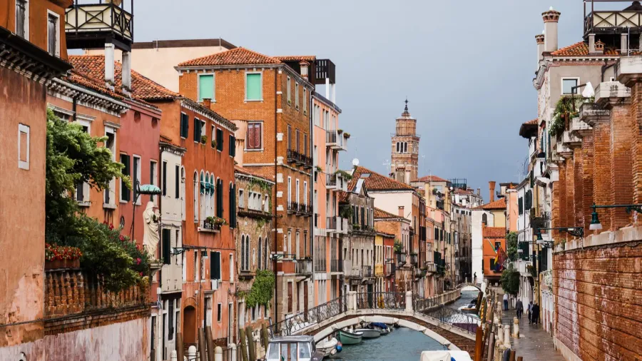 bridge above canal motor boats and ancient buildings in venice
