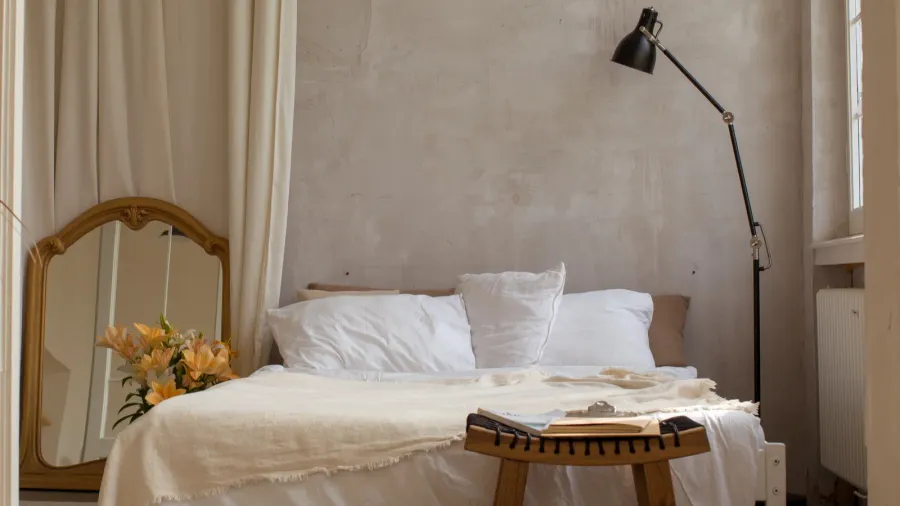 bright bedroom with empty bed copy space