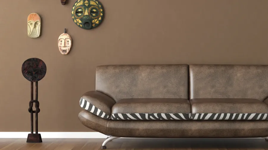 brown wall with tribal masks and couch