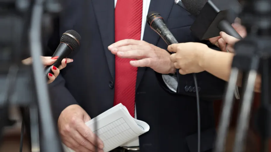 Business meeting with microphones for journalism conference.