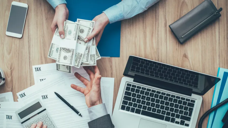 business woman giving packs of dollars