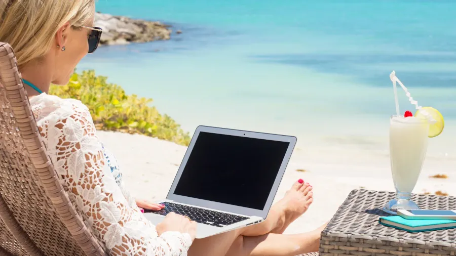 business woman working with computer on the beach
