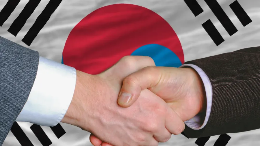 businessmen handshake after good deal in front of south korea