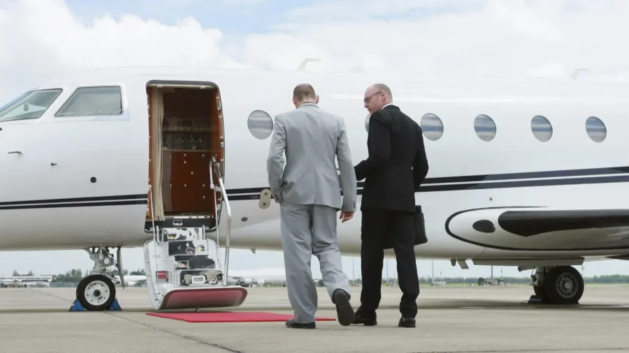 businessmen walking towards private jet
