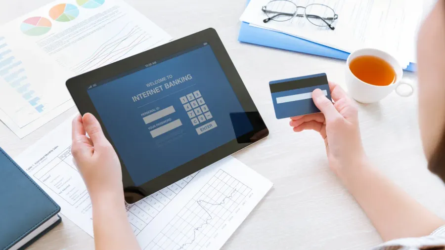 businesswoman using a credit card for online internet banking