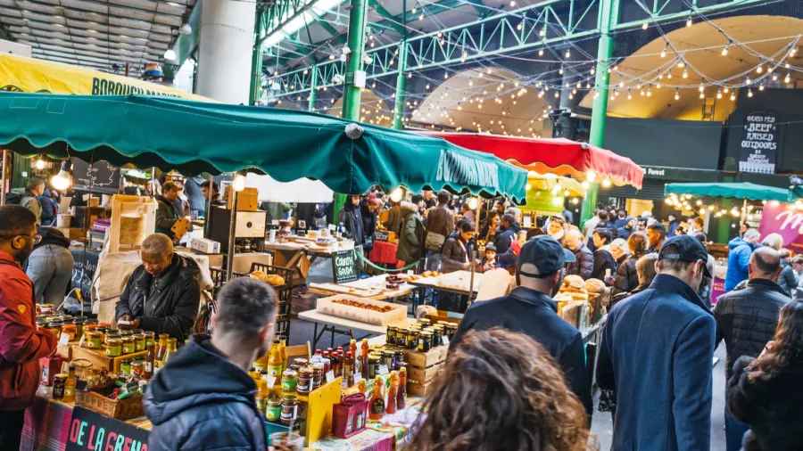 bustling borough market packed with shoppers enjoying fresh food stalls