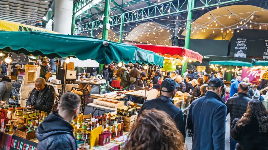 bustling borough market packed with shoppers enjoying fresh food stalls